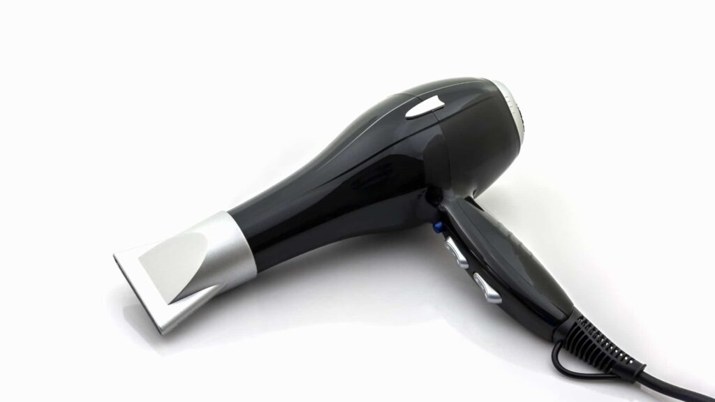 black and silver color hair dryer placed on the white surface.